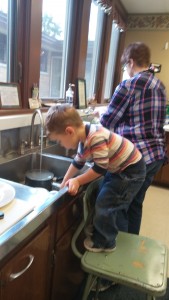 Henry Benson helps with the dishes after Wednesday lunch